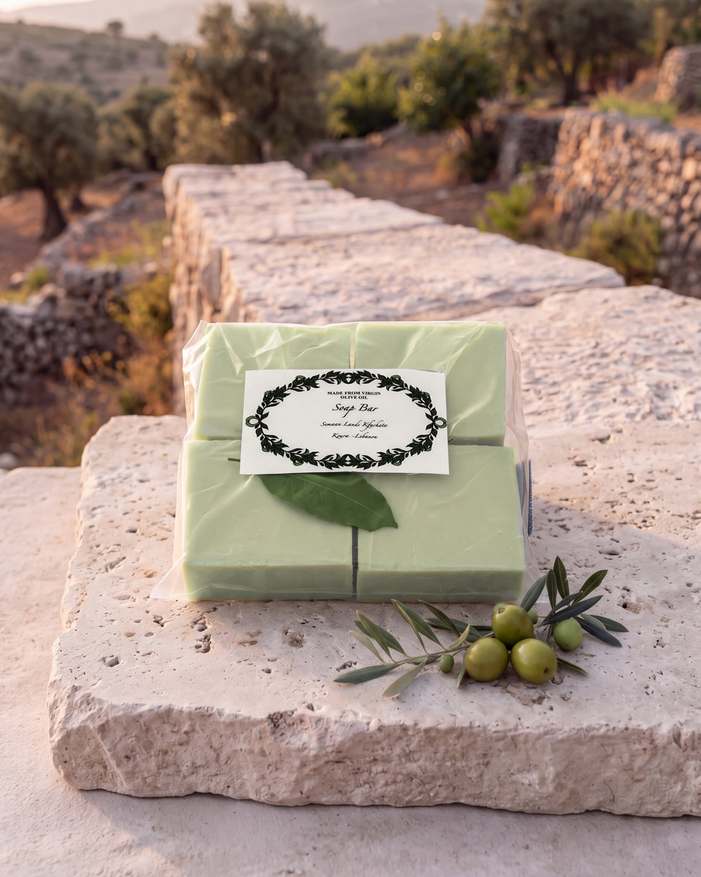 A bag of our olive-oil soap bars on a limestone ledge, a studio photo of the real bag
